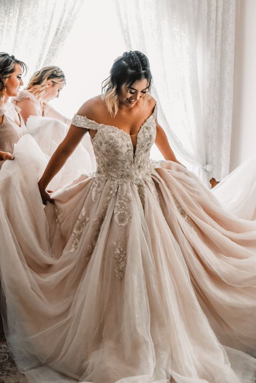 Bride turning in her ballgown in the bride's room at On Collin's Pond