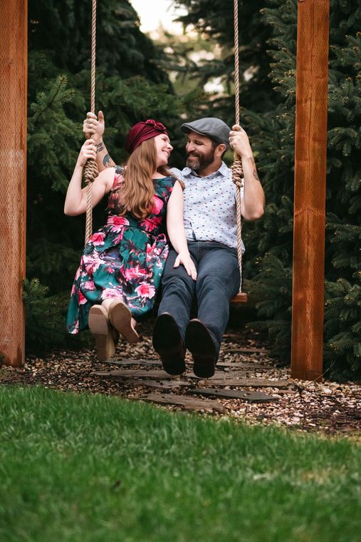 Couple laughing together on the garden swing at On Collin's Pond