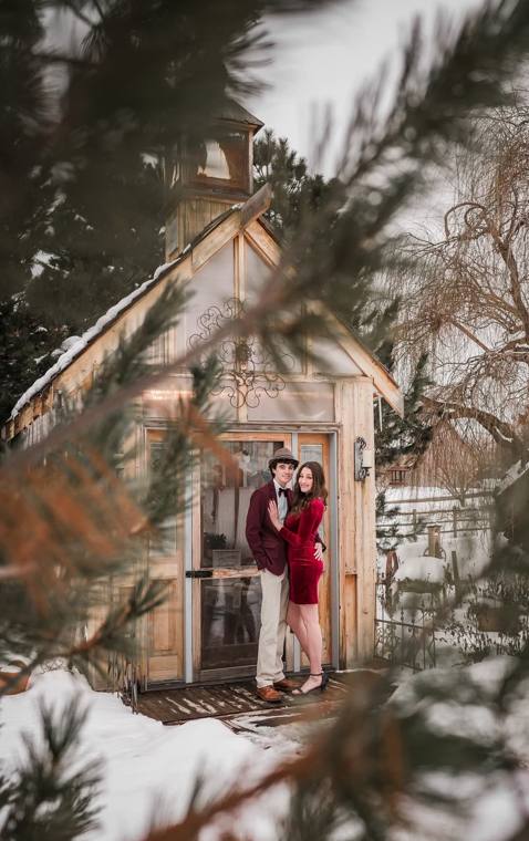 Couple at the garden chapel doors on a snowy winter day at On Collin's Pond