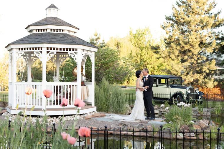 Newlyweds at the gazebo across the koi pond at On Collin's Pond wedding venue in Middleton, Idaho