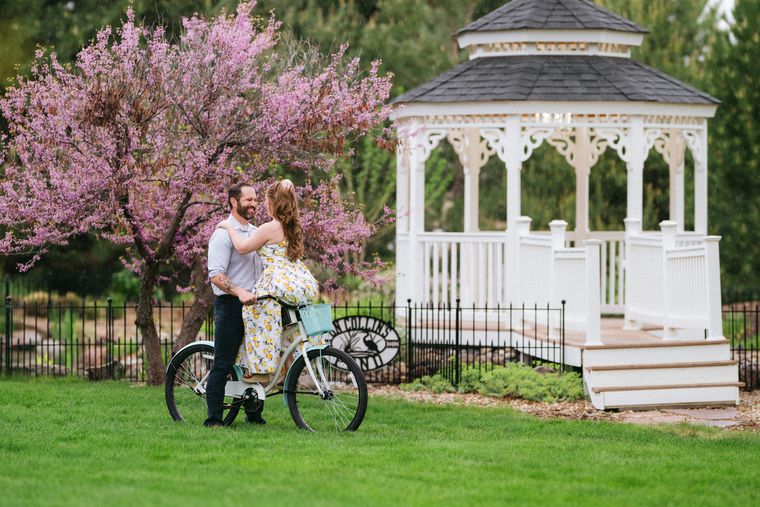 The white gazebo framed by spring blossoms at On Collin's Pond garden venue