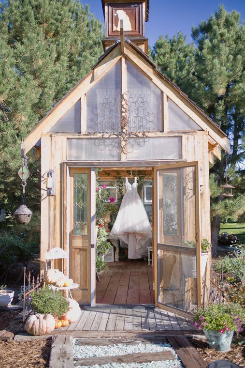 Wedding gown hanging in the doorway of the garden chapel at On Collin's Pond in Middleton, Idaho