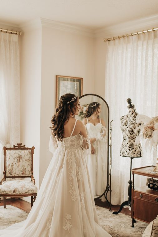 Bride checking her gown in the standing mirror of the bride's room at On Collin's Pond