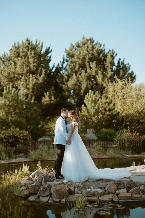 Bride and groom beside the water gardens at On Collin's Pond garden wedding venue
