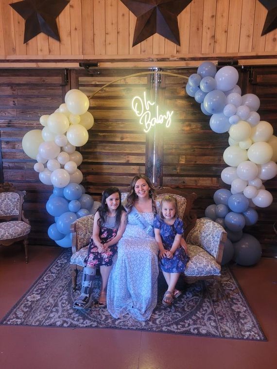 Mother and her daughters at a baby shower in the lodge at On Collin's Pond