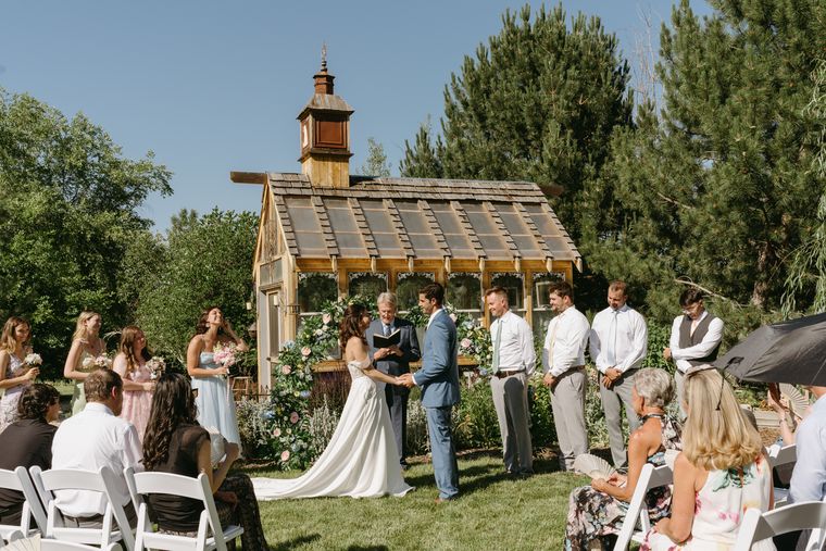 Bridal party gathered at the garden chapel during a ceremony at On Collin's Pond