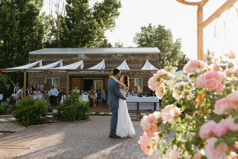 Reception on the patio framed by blossoms at On Collin's Pond in Middleton, Idaho