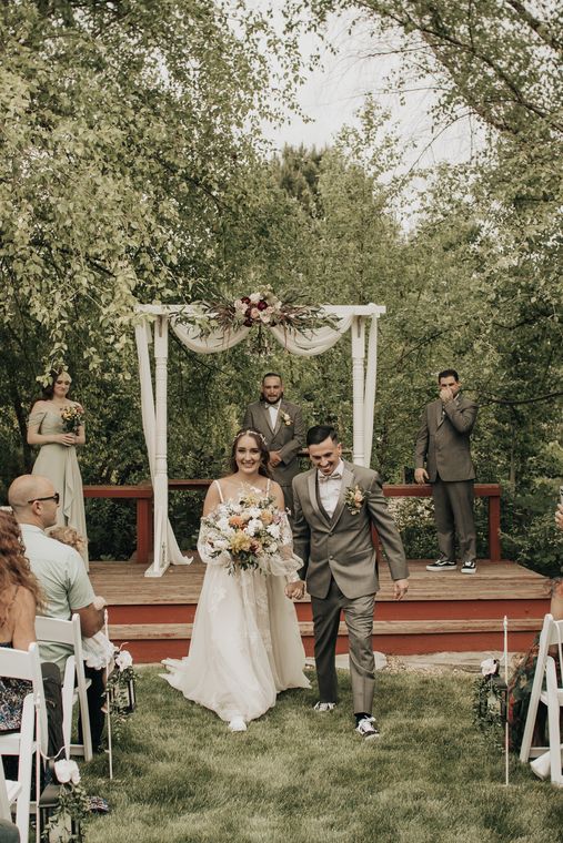 Garden ceremony at the floral arch beneath the willow at On Collin's Pond
