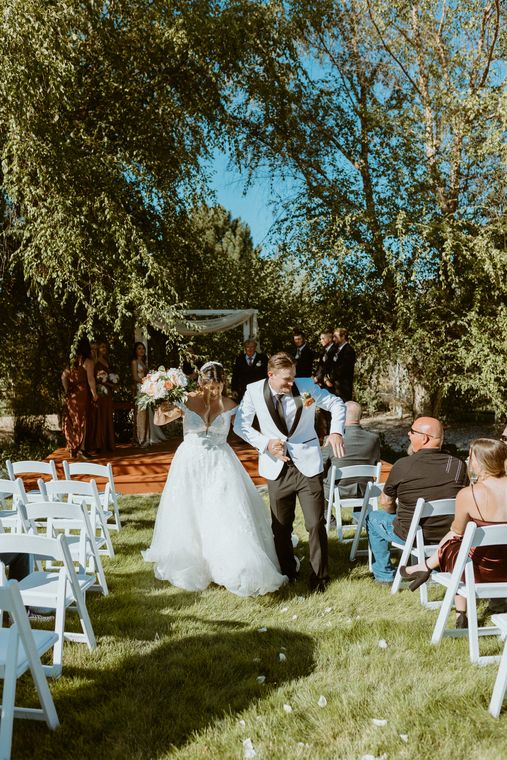 Wedding ceremony on the lawn under open sky at On Collin's Pond in Middleton, Idaho