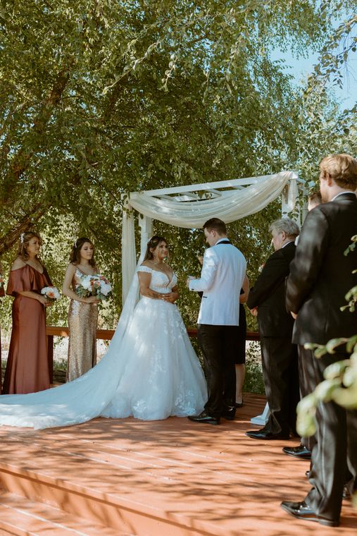 Bride at the ceremony platform with her bridesmaids at On Collin's Pond
