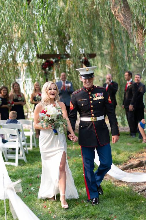 Bride and Marine groom walking the aisle beneath the Grandmother Willow at On Collin's Pond