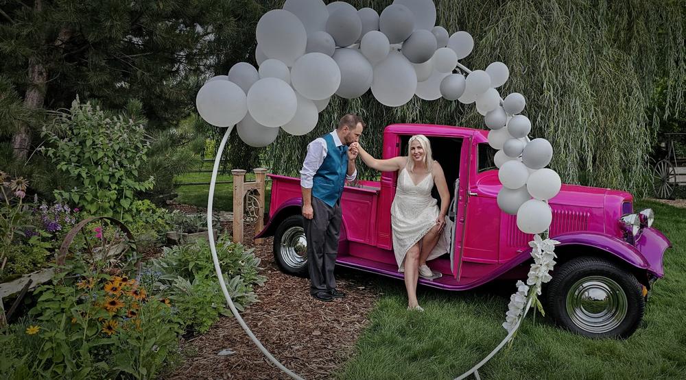 Vintage pink truck styled with balloons for a party in the gardens at On Collin's Pond, Middleton, Idaho