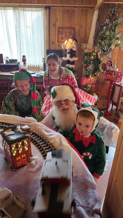 Children watching the model train in Santa's Lodge at On Collin's Pond