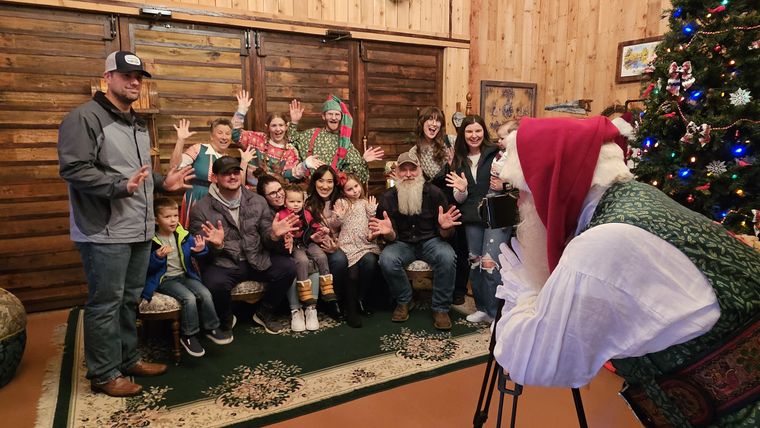 A group photograph with Santa Phil beside the Christmas tree at On Collin's Pond
