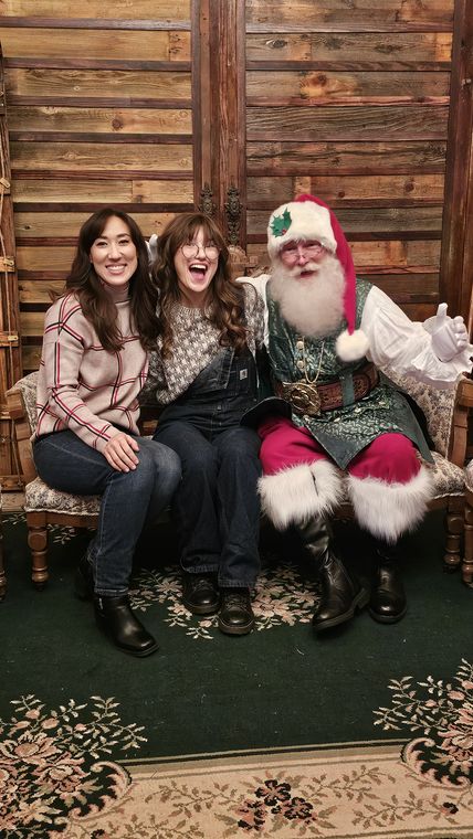 Santa Phil with two guests in the lodge at On Collin's Pond