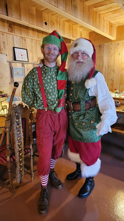 Santa Phil and an elf in the lodge at On Collin's Pond