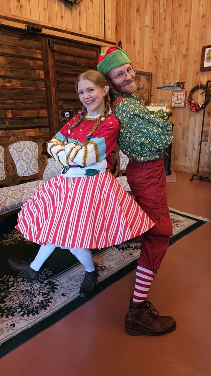 An elf dancing with a guest in the lodge at On Collin's Pond