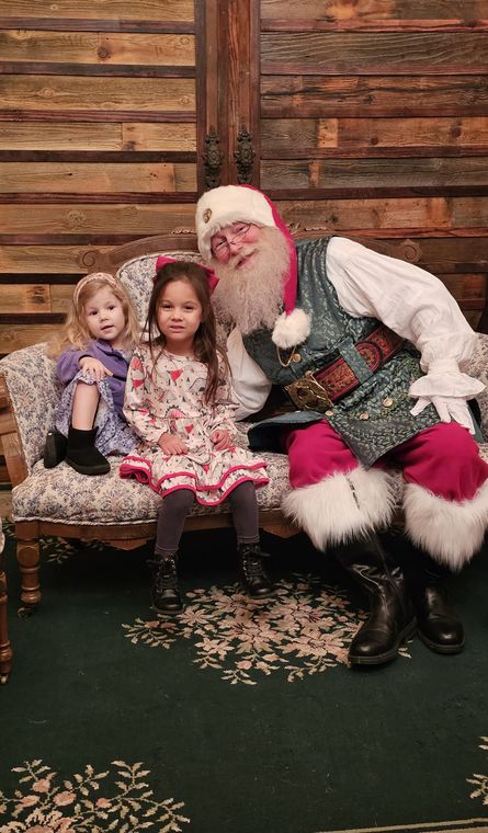 Santa Phil with two young sisters on the settee at On Collin's Pond