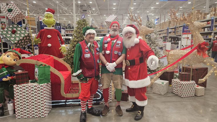 Santa Phil and his elves beside the sleigh at an off-site Christmas event