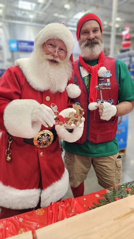 Santa Phil and an elf at the craft table during an off-site Christmas event