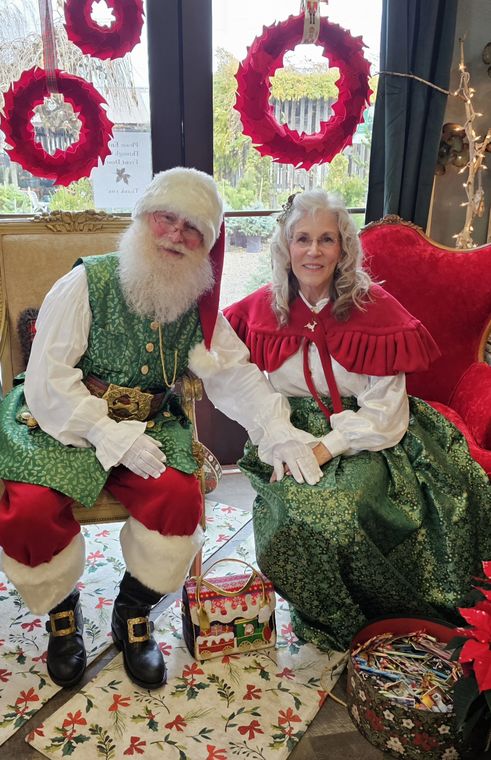 Santa Phil and Mrs. Claus welcoming visitors at an off-site Christmas event