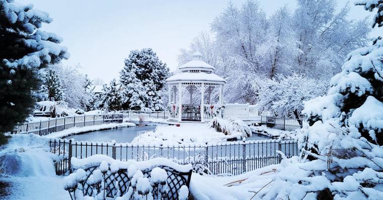 The gazebo and koi pond blanketed in snow at On Collin's Pond in Middleton, Idaho