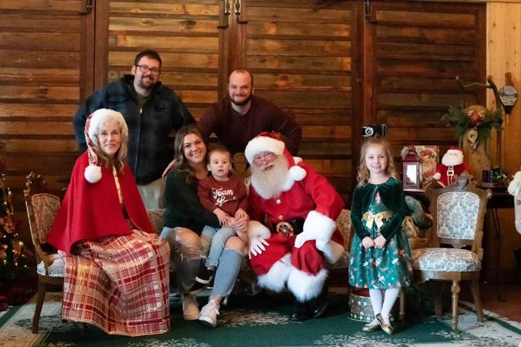 A family portrait with Santa and Mrs. Claus in the lodge at On Collin's Pond