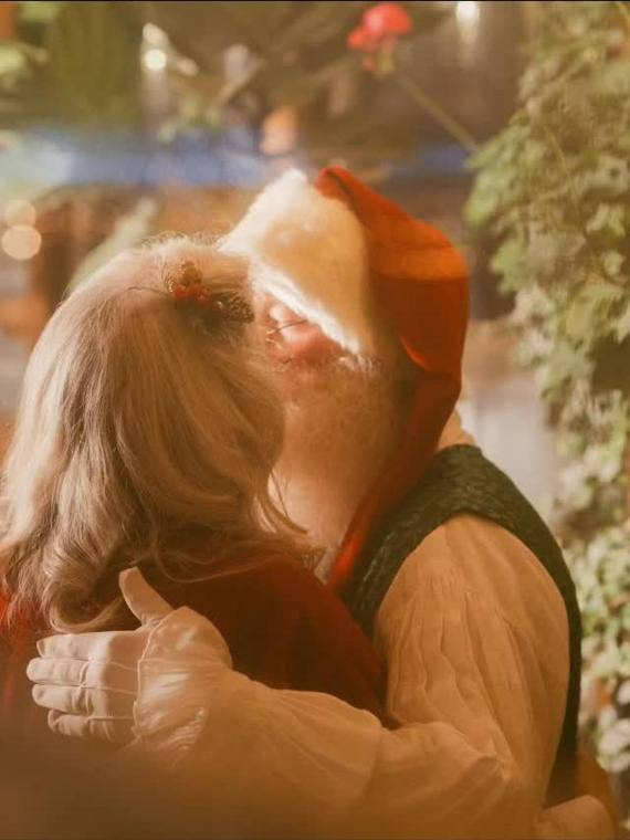 Santa embracing a child in warm golden Christmas light