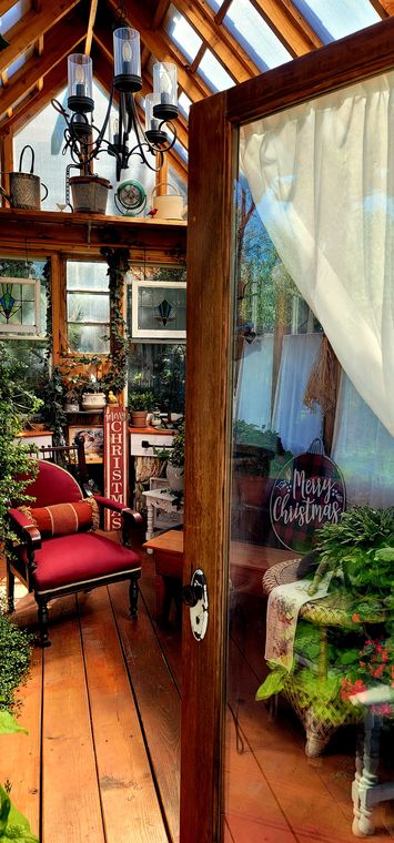 Inside the old-world greenhouse decorated for Christmas at On Collin's Pond