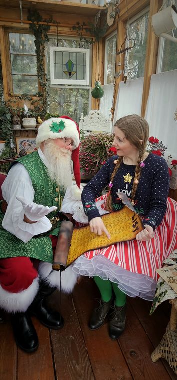 A visitor with an elf inside the greenhouse at On Collin's Pond