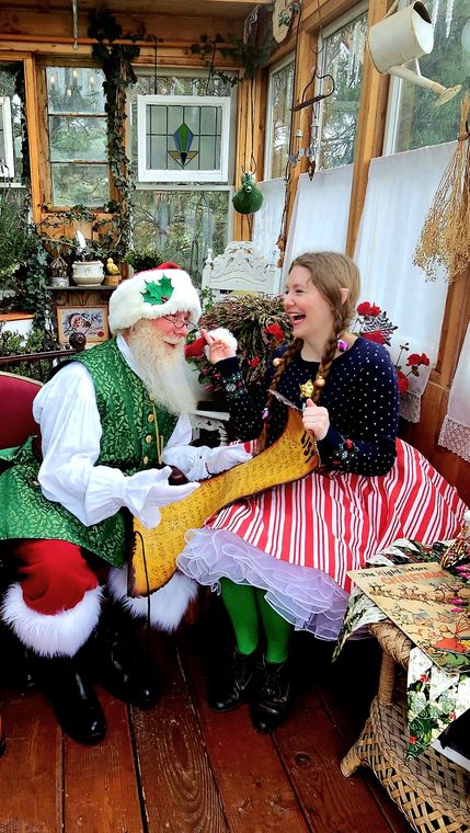 An elf and guest sharing a laugh in the greenhouse at On Collin's Pond