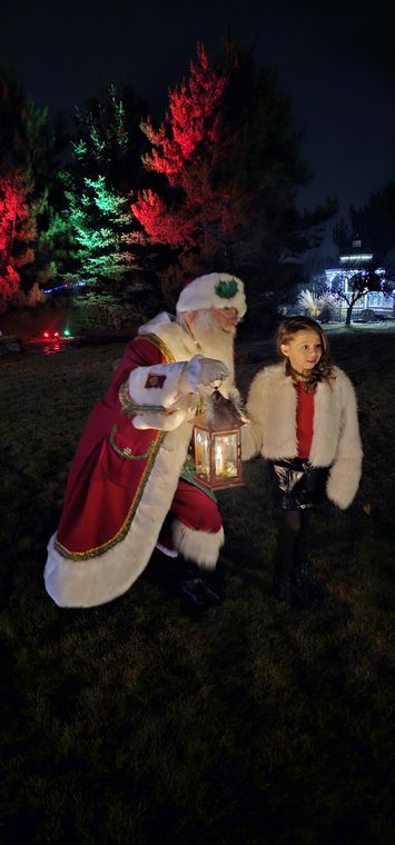 Santa Phil with his lantern on the grounds at night at On Collin's Pond