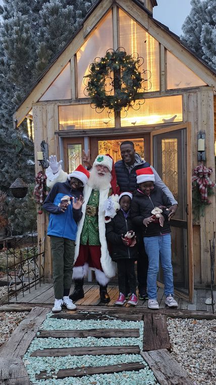 Visitors with Santa Phil at the garden chapel in the snow at On Collin's Pond