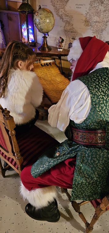 Santa Phil and Mrs. Claus at the writing desk in the workshop at On Collin's Pond