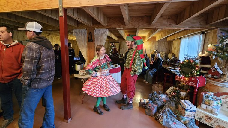 Guests gathered inside Santa's Lodge and Workshop at On Collin's Pond