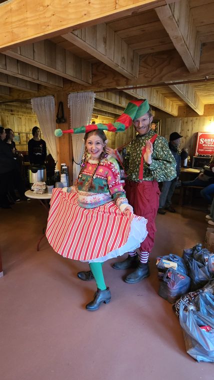 An elf welcoming guests in Santa's Lodge at On Collin's Pond